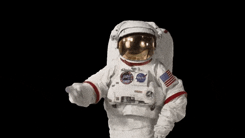 astronaut doing a pointing gesture to his head