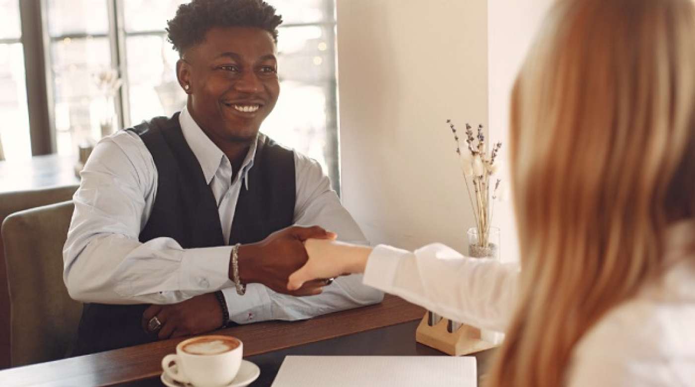 Teen boy shaking hands during a job interview