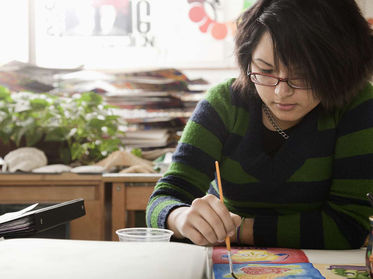 A student paints in art class.