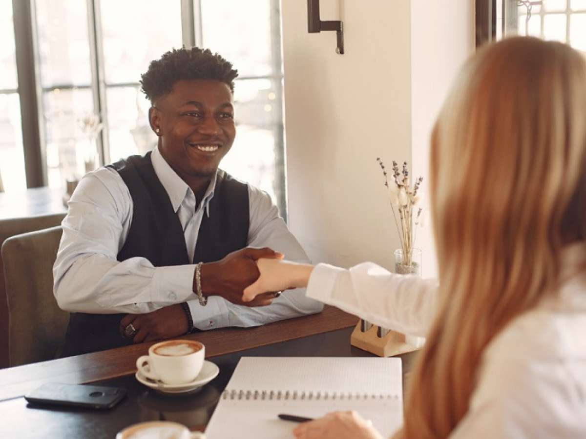 Teen boy shaking hands during a job interview