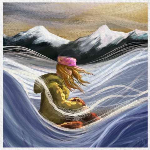 A girl in a pink hat sits in a snowy plain with mountains in the background.